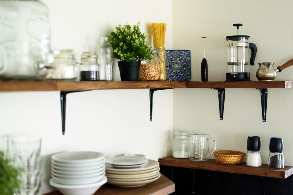 open shelving with coffee maker and dishes in small kitchen