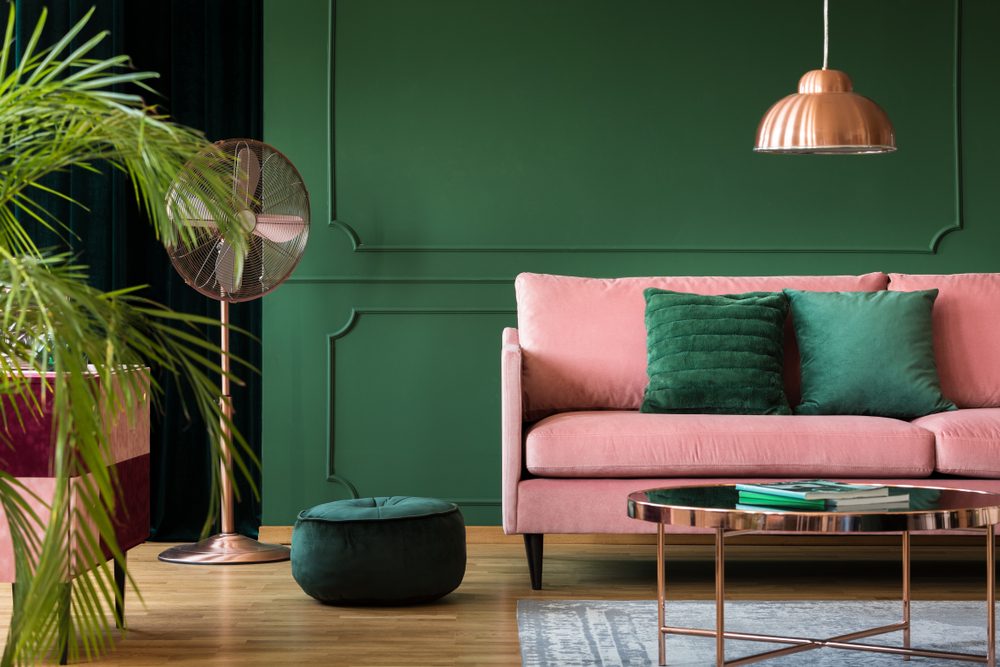 pink sofa with green wall in living room
