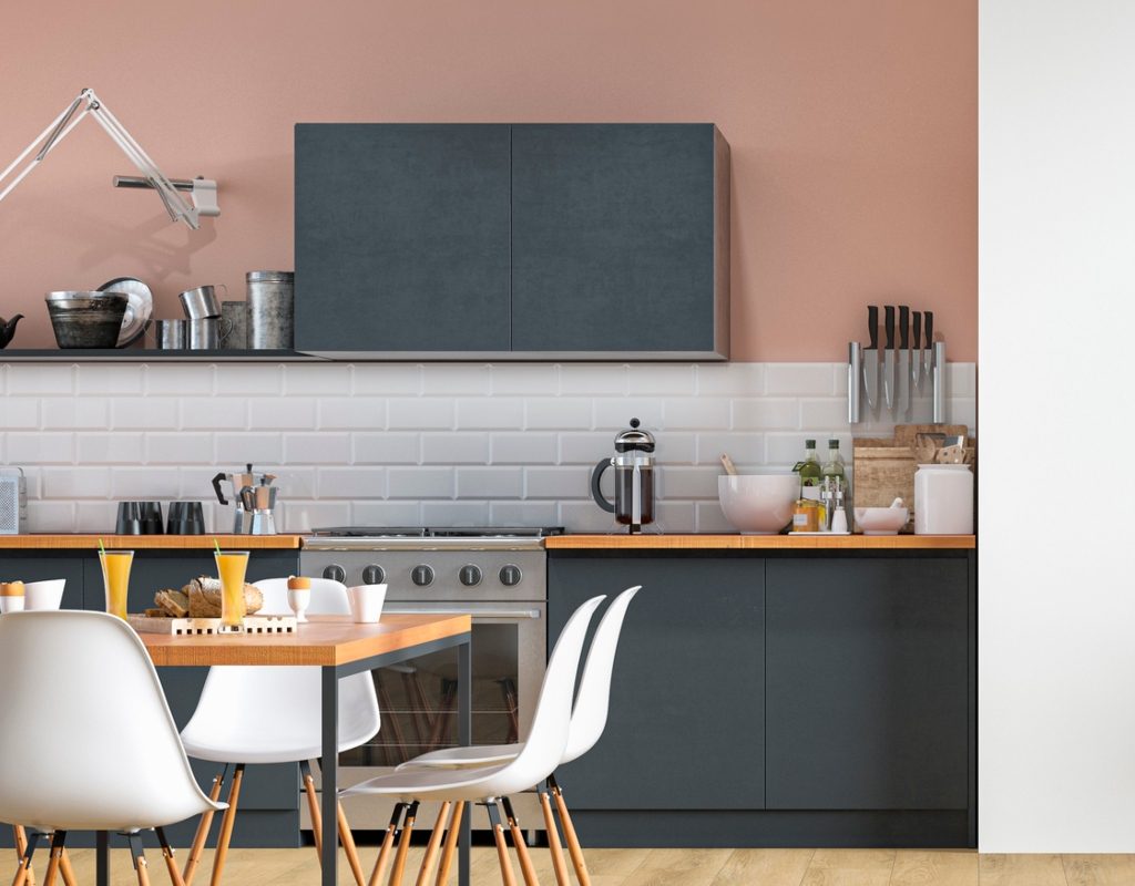 pink kitchen walls with black cabinets and white backsplash