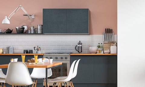 Pink kitchen walls with black cabinets and white backsplash