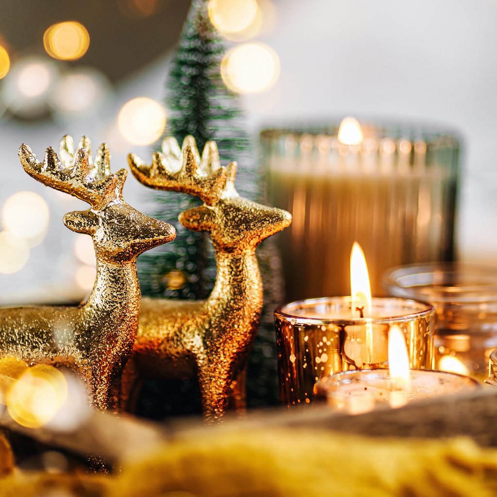 Burning candles and Christmas decorations on wooden tray