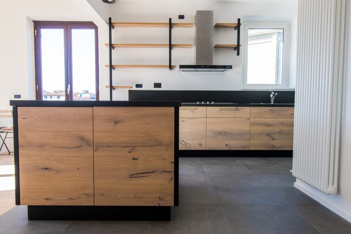 modern black and white kitchen with oak cabinets
