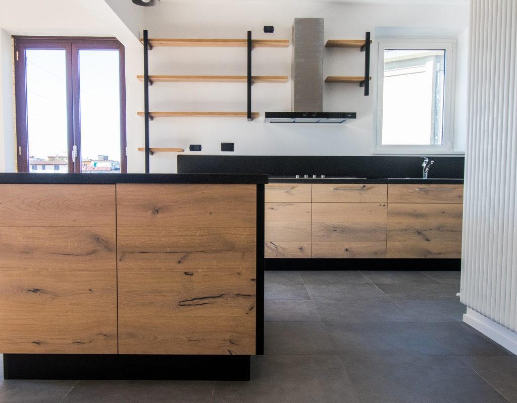 modern black and white kitchen with oak cabinets