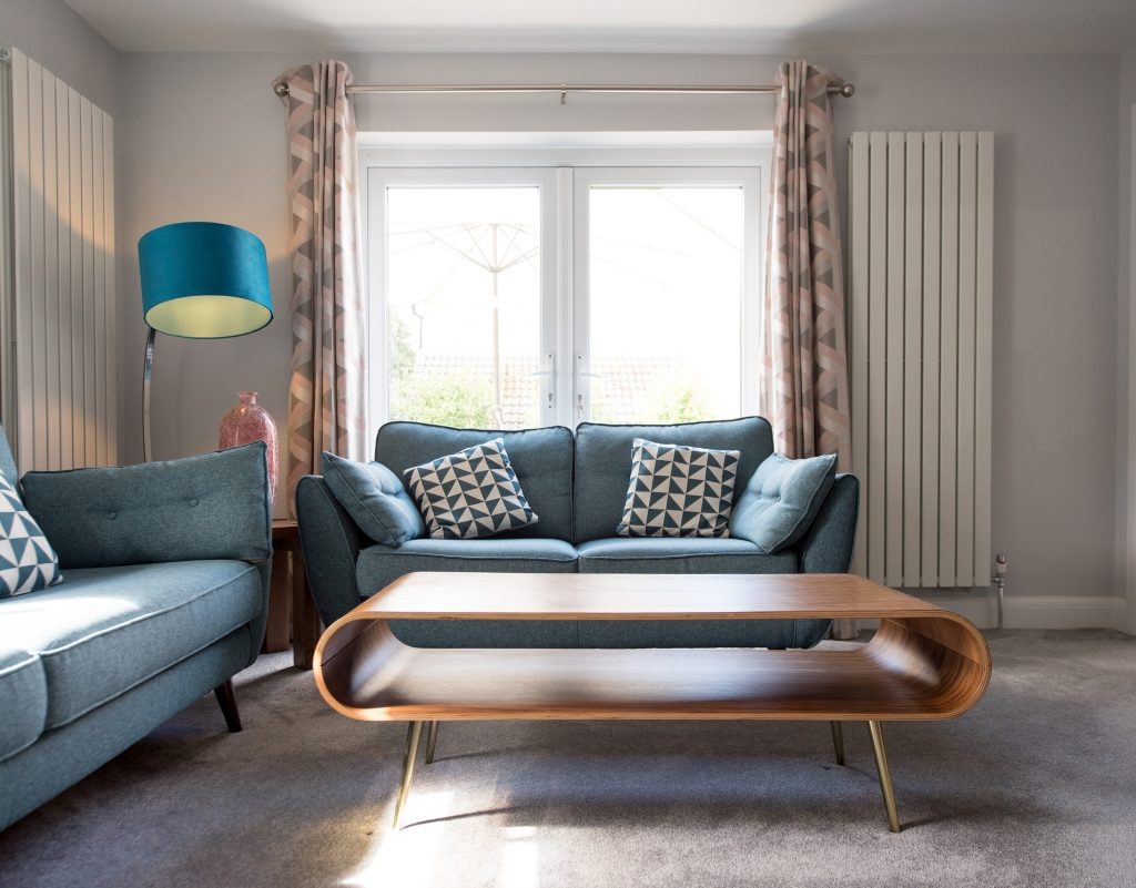 Retro living room with curved coffee table and blue sofas
