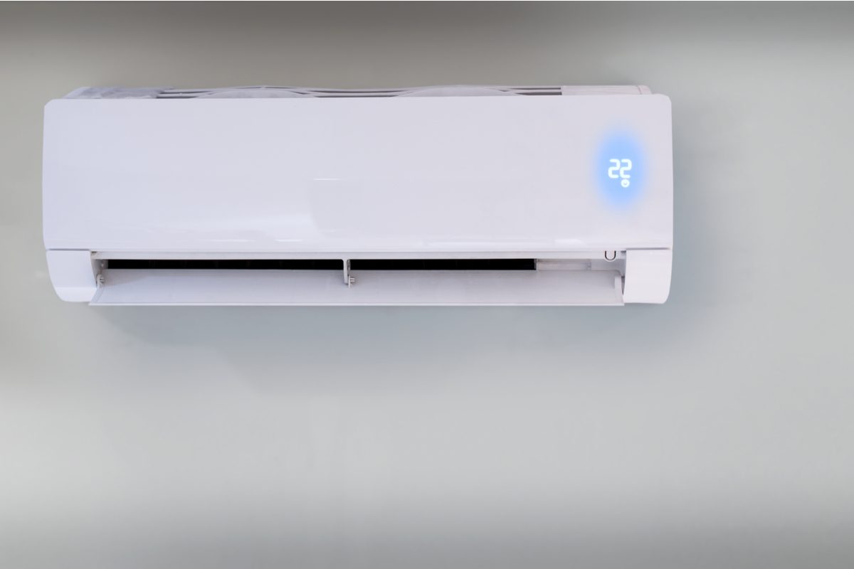 Ductless heating and cooling unit on white wall