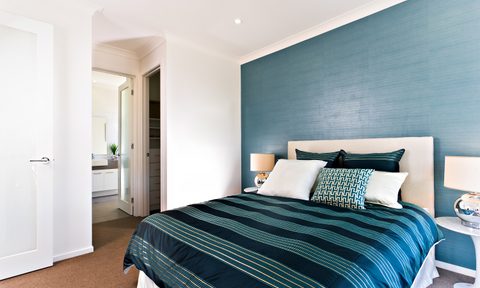 Bedroom with dark wall behind king bed