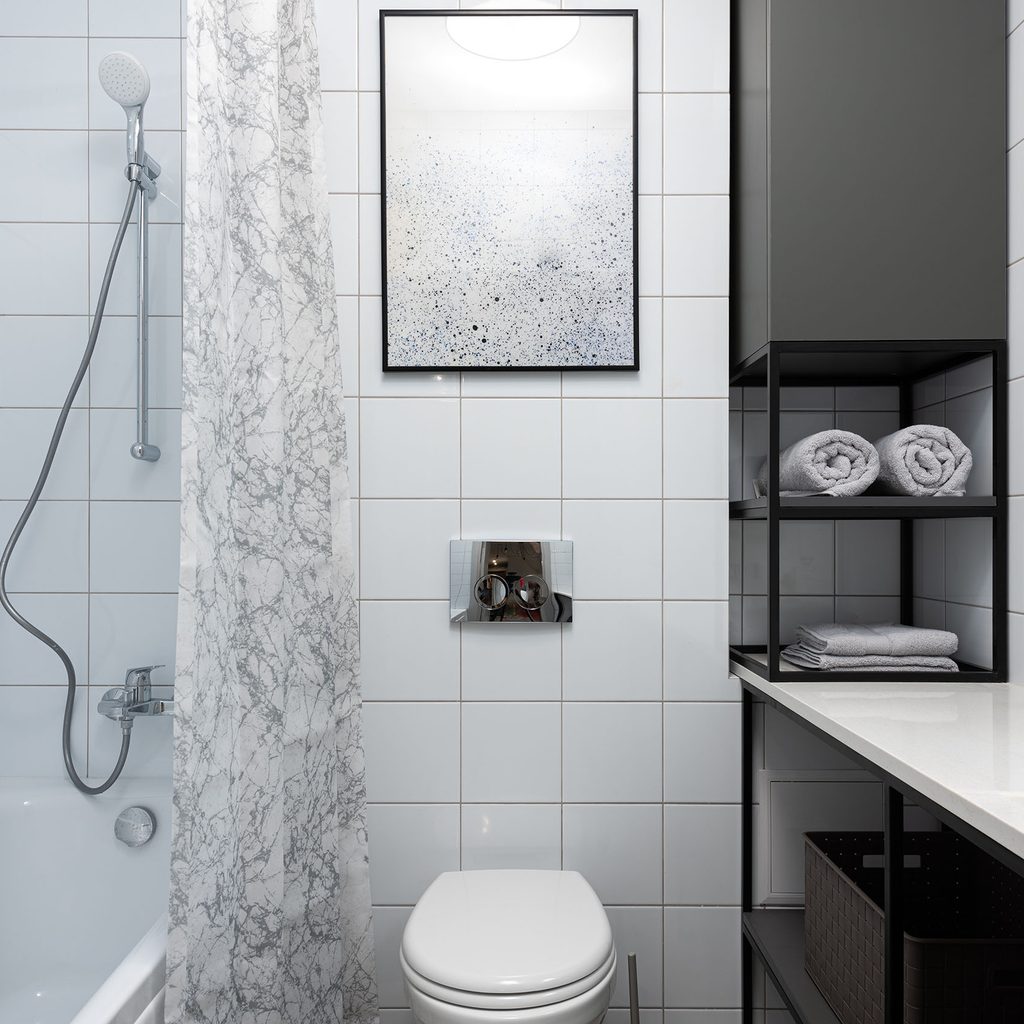 Wall art hanging in the bathroom above the toilet