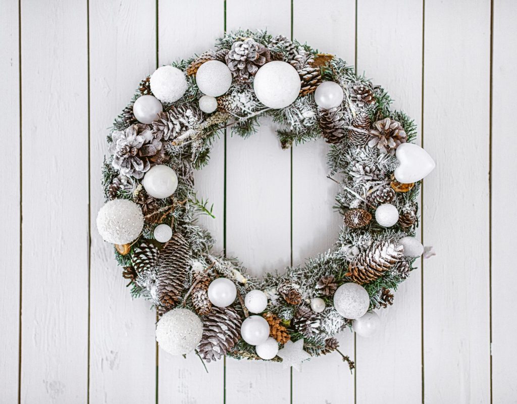 White evergreen winter wreath on a white background