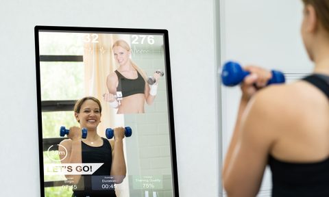 Woman exercising using a smart mirror