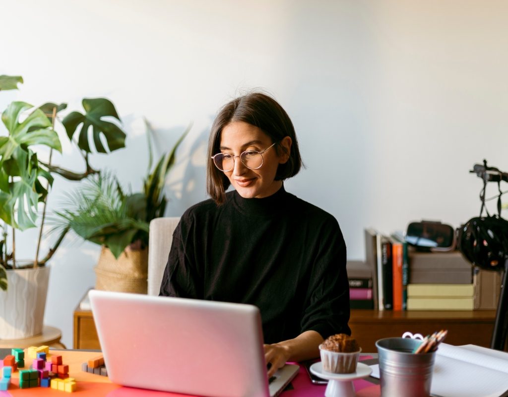 woman working in home office surrounded by plants