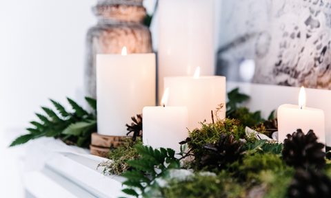 vintage fireplace mantel decor with metal milk jug and candles