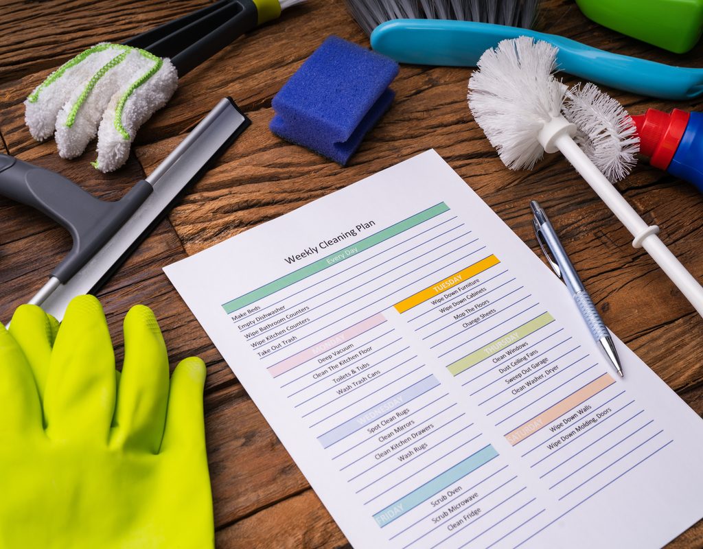 Cleaning supplies and checklist on a table