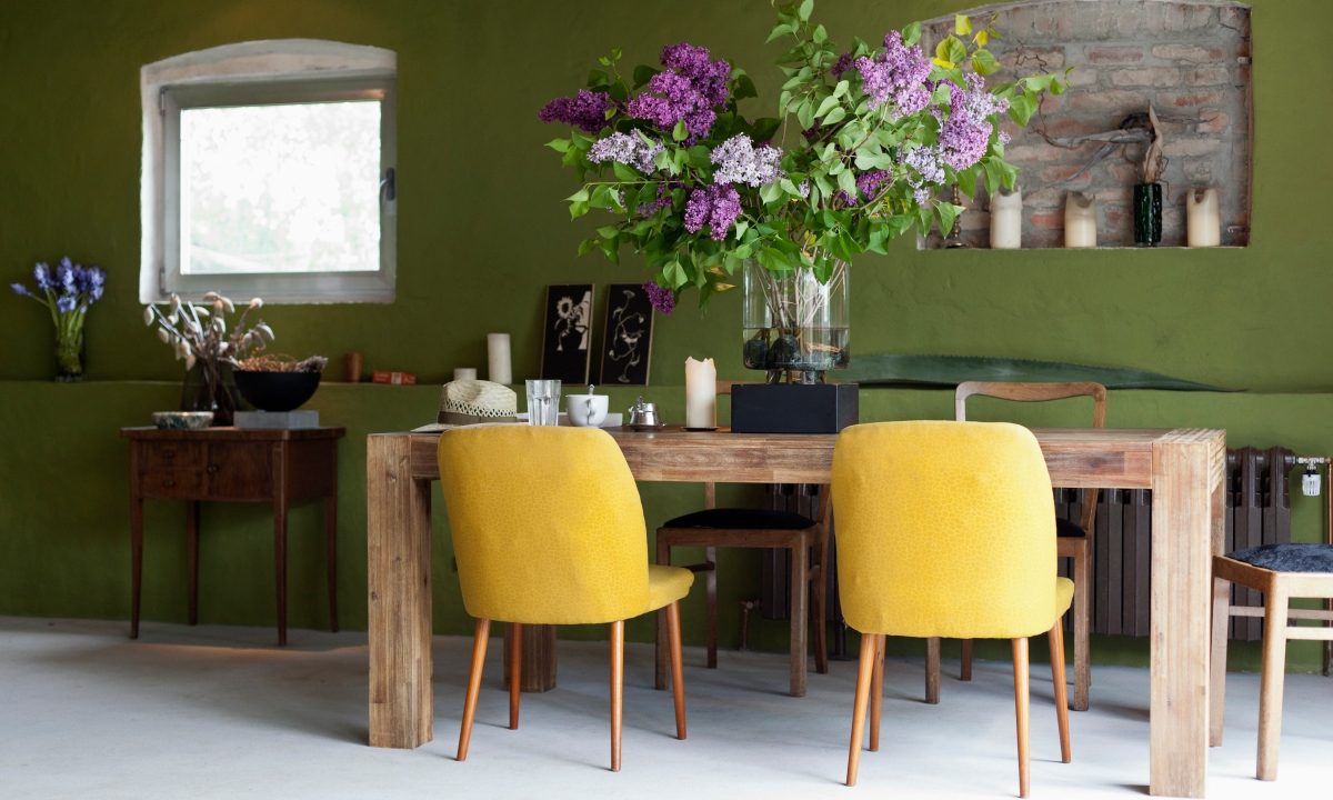 green dining room with yellow chairs