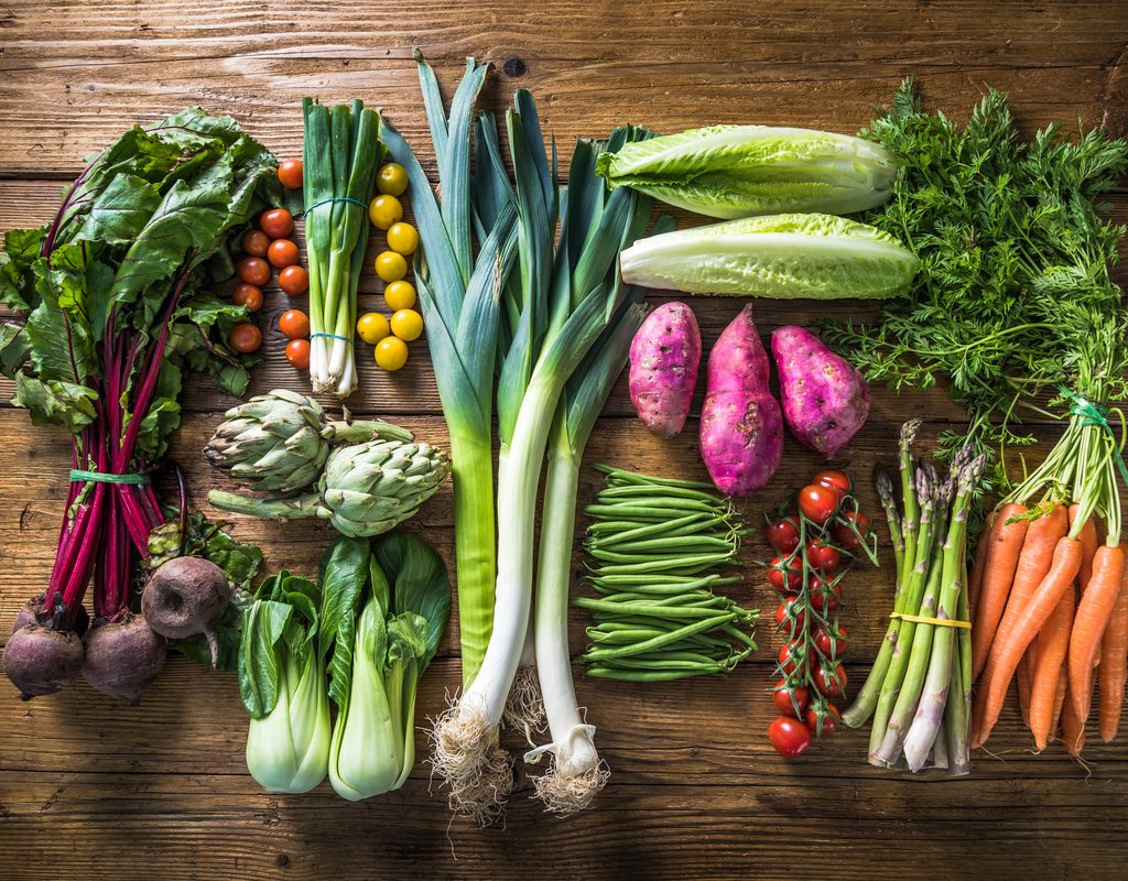 Assorged fresh vegetables on a wood surface