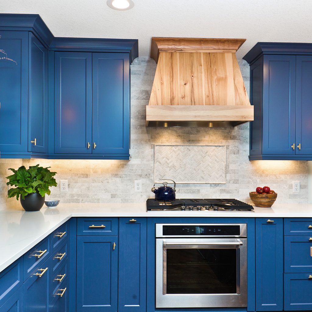 Kitchen with blue frame fronted cabinets