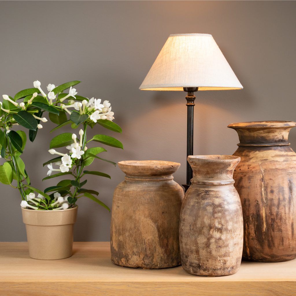 Clay pottery vases beside lamp on table