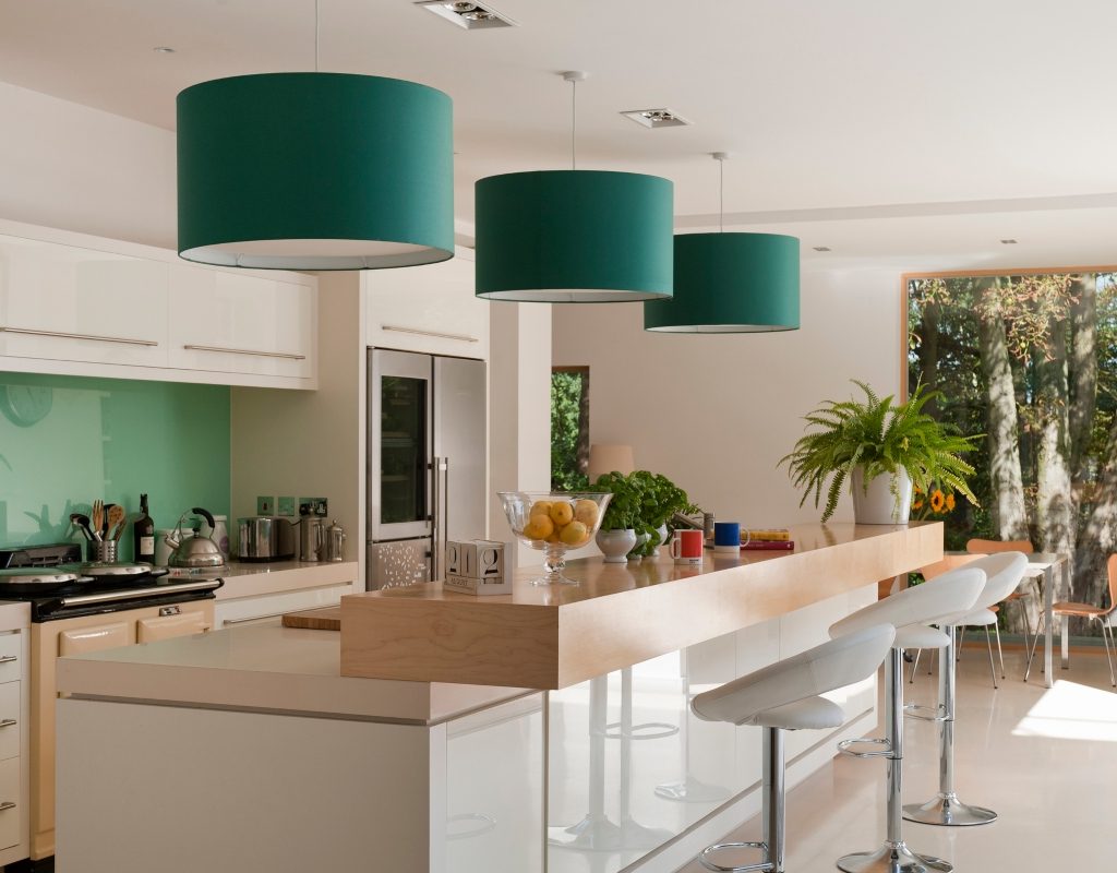 Green round pendant drum lights above kitchen island
