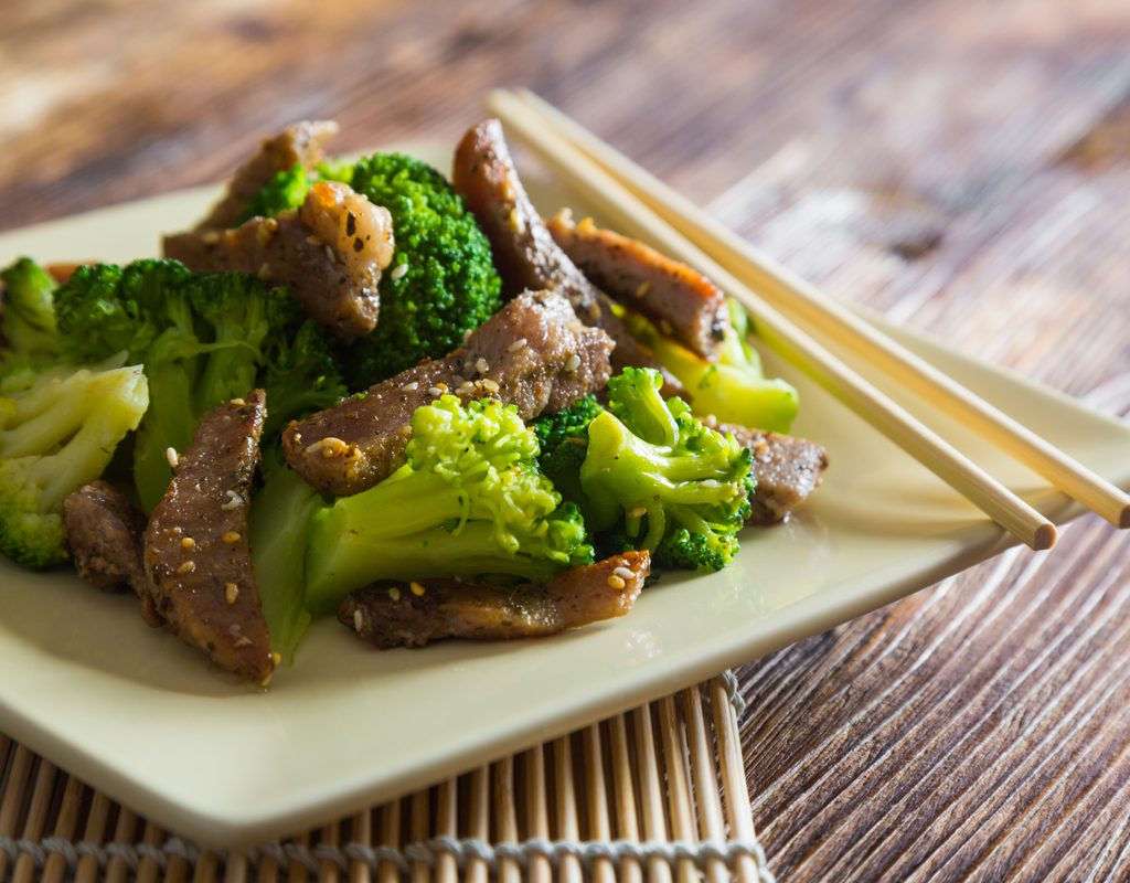Beef and broccoli dish with chopsticks