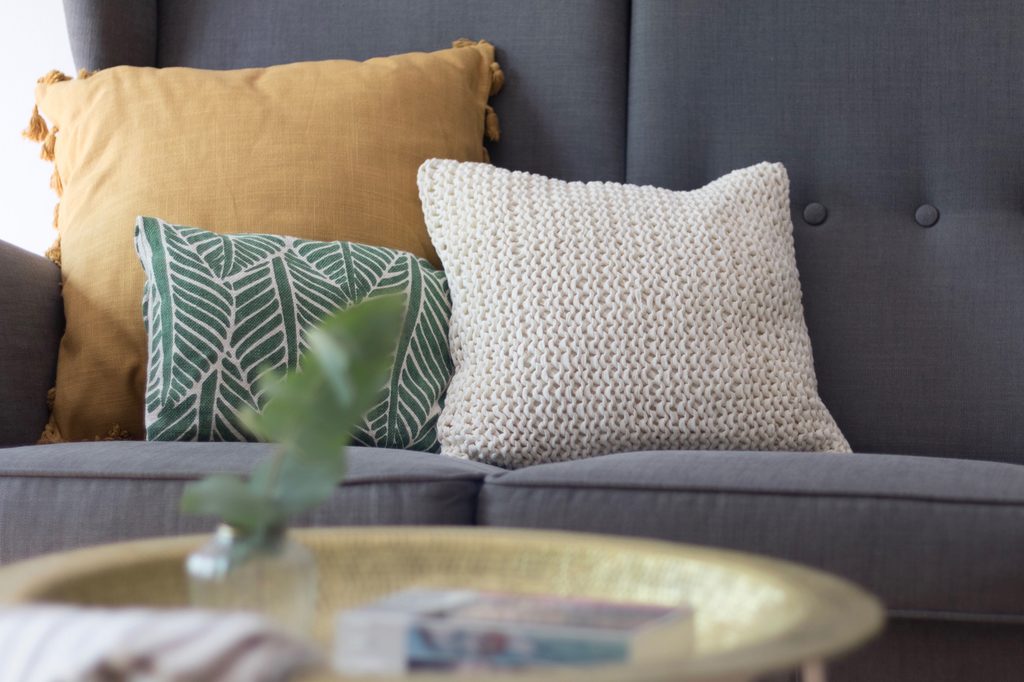 Three throw pillows on a sofa