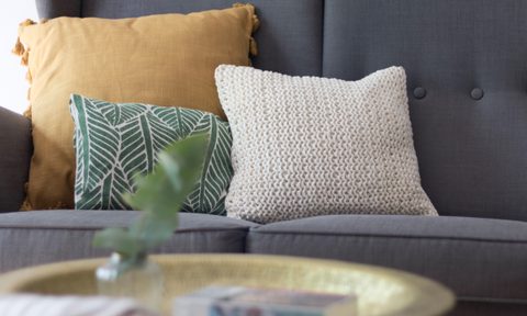 Three throw pillows on a sofa