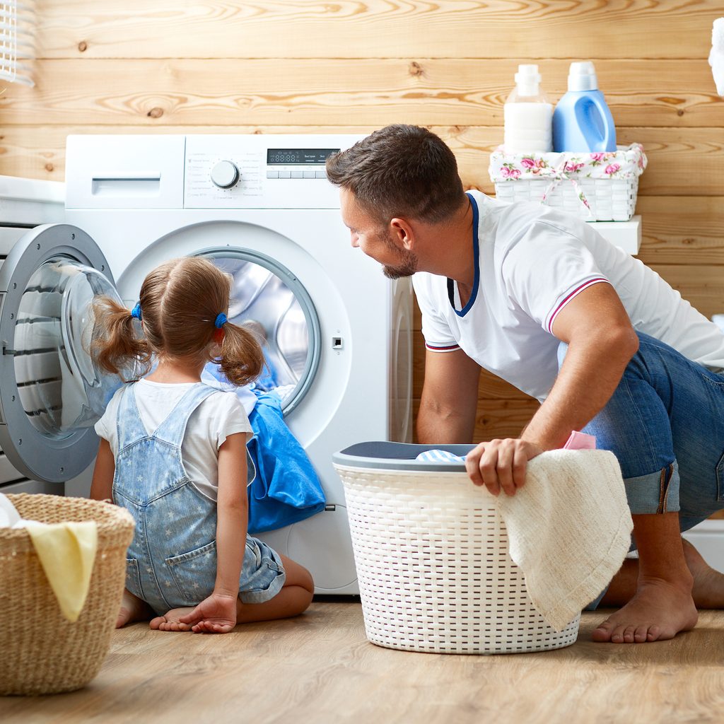 Father and daughter doing laundry