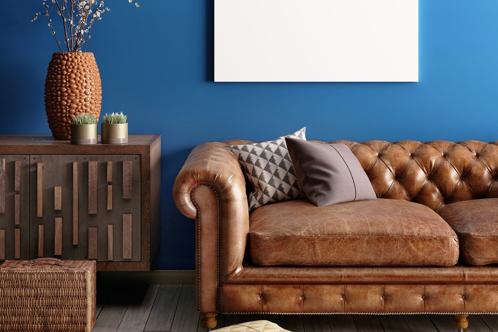 Brown furniture against a blue wall