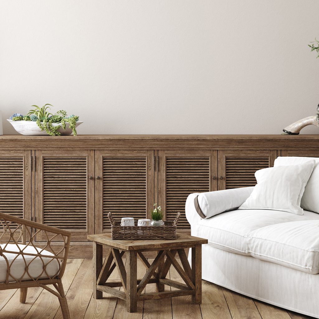 Coastal farmhouse living room with white couch and rustic accents