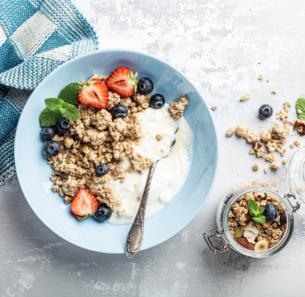 Granola with fruit and milk in bowl.