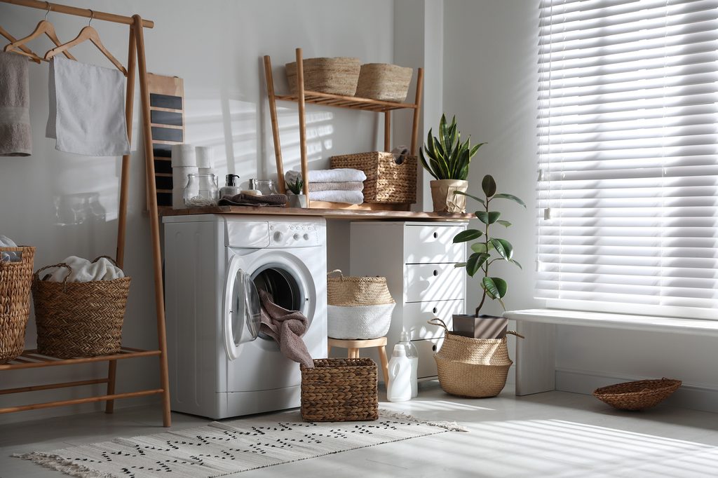Laundry room decorated with plants and woven baskets
