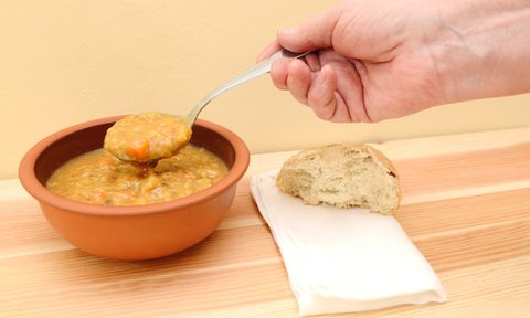 Person eating lentil soup.