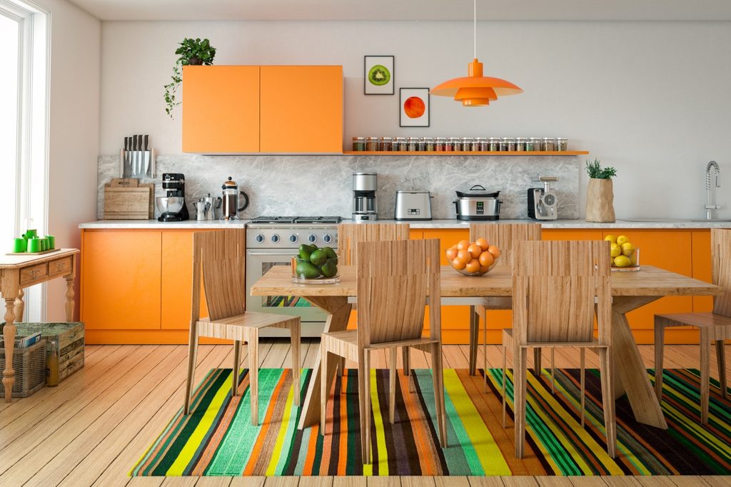 Orange and wood kitchen cabinets in brightly colored kitchen