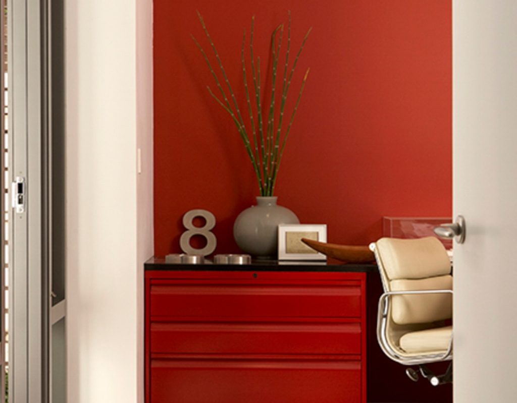 red office accent wall and dresser