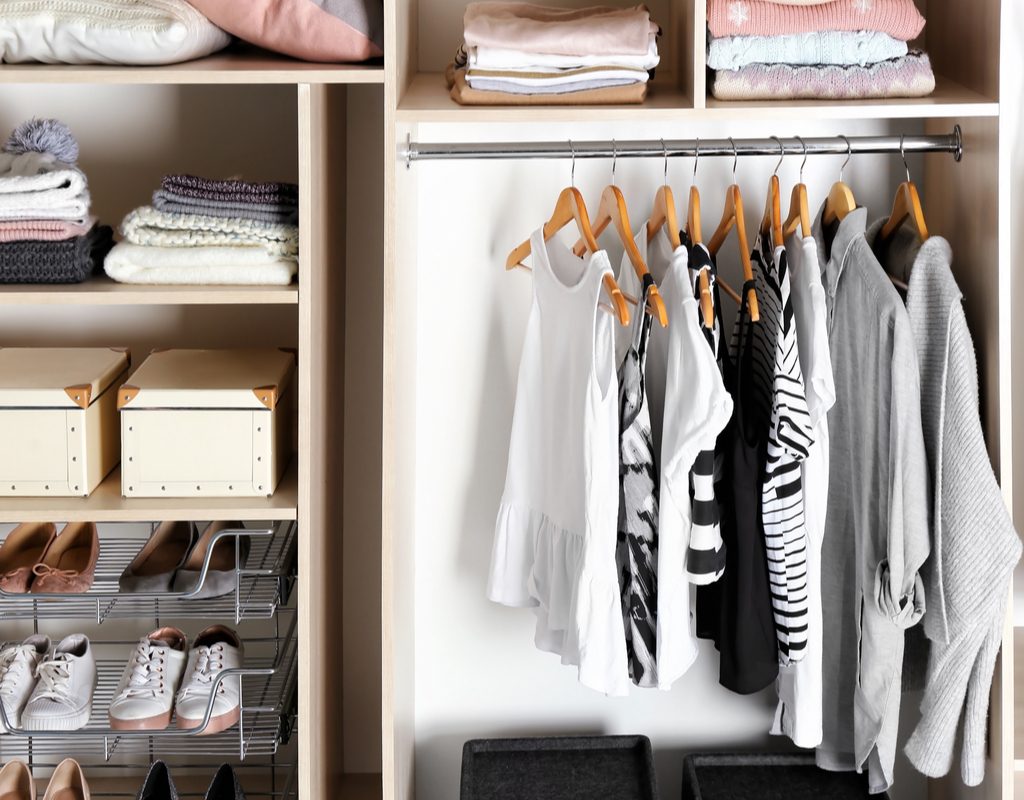 closet with built-in storage and drawers for saving space with folded clothing