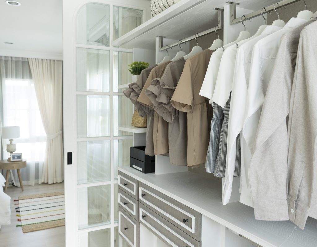 Built-in closet with drawings and hanging white tshirts