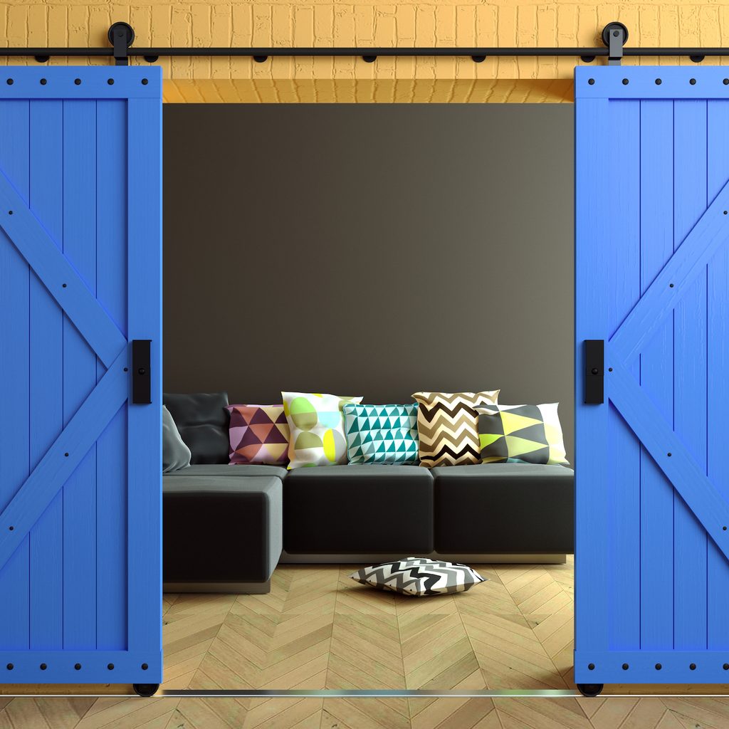 Modern interior in loft-style with barn sliding wooden door