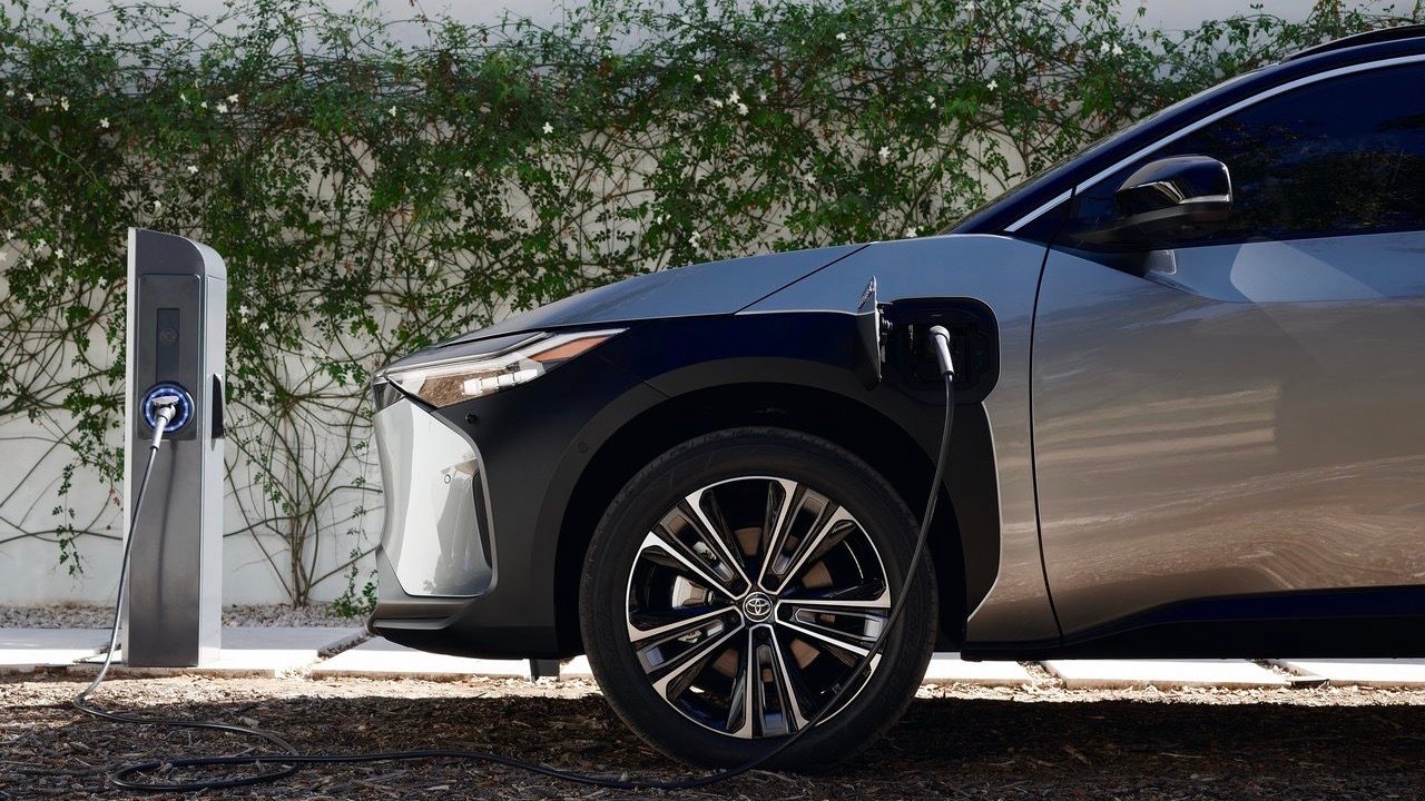 Toyota bZ4x front end side view being charged.