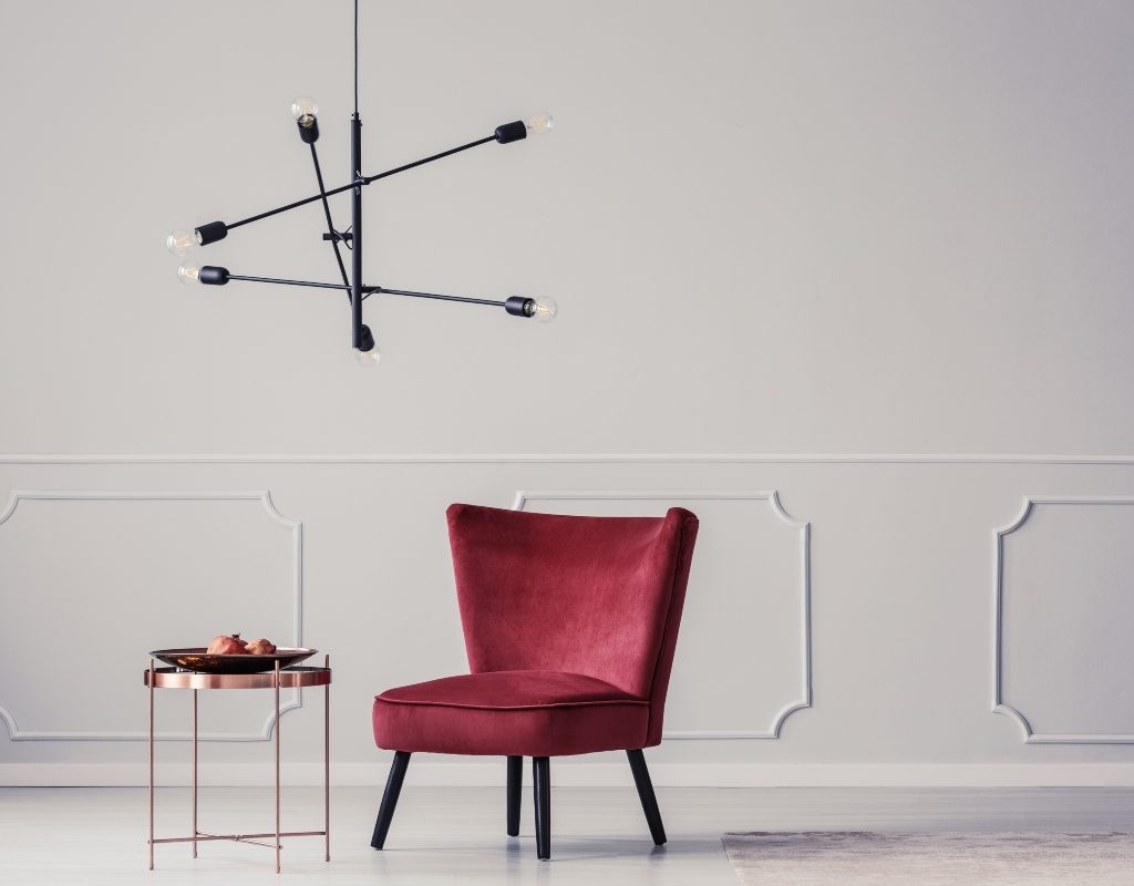Beetroot and magenta colored chair in a white room