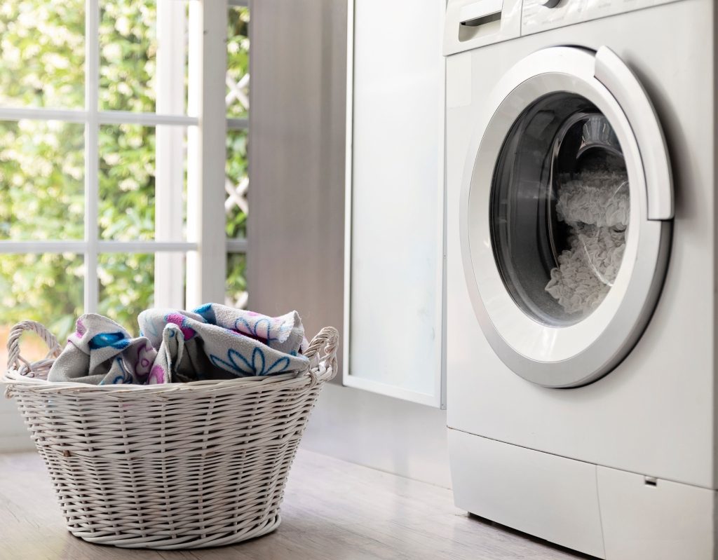 Close-up of a laundry basket and washing machine