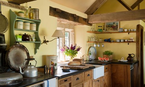 cluttered cottage kitchen design with rustic beams