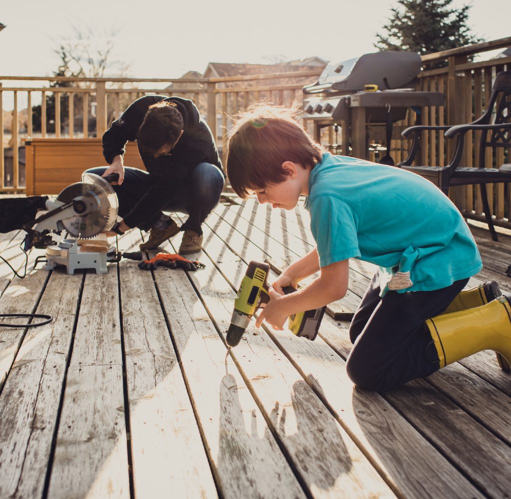Dad and kid building a deck.