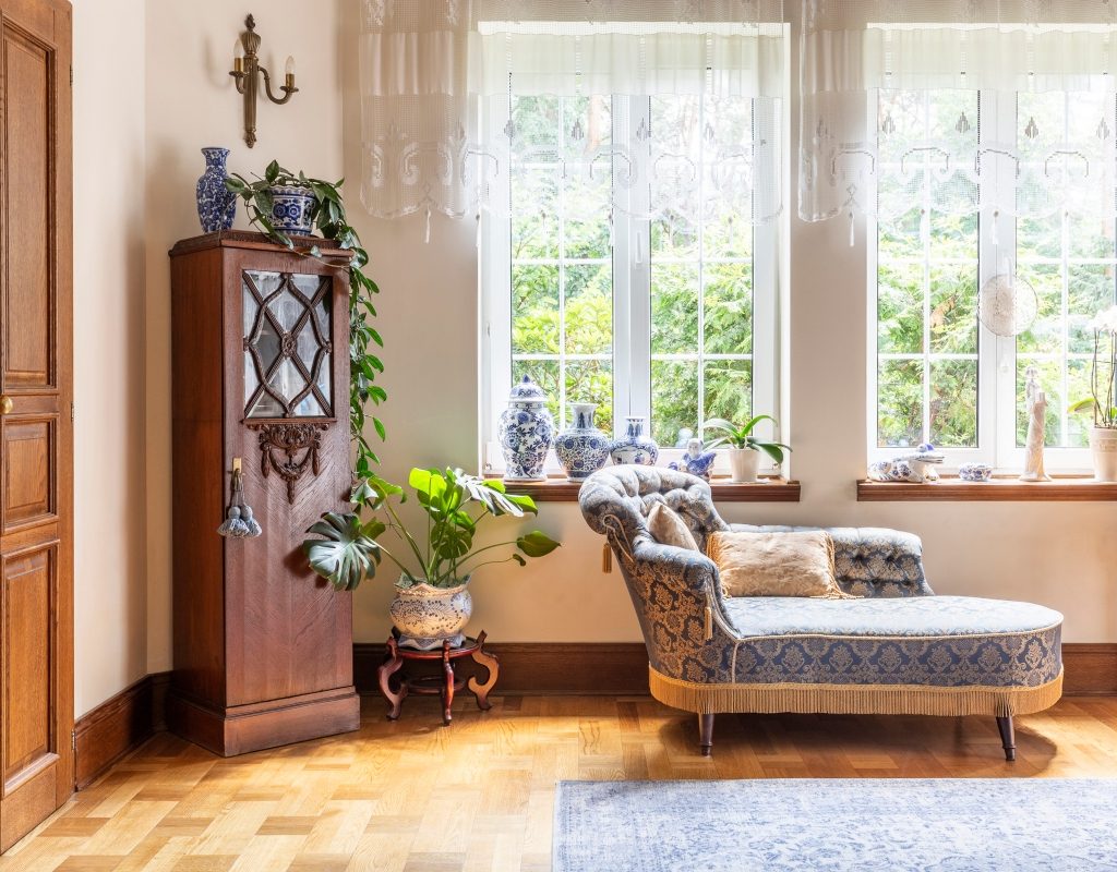 Vintage decor with grandmillenial chaise lounge and traditional cabinet