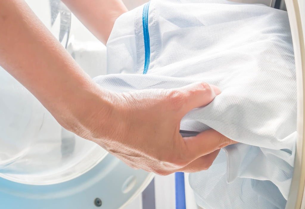 Person using laundry bag while cleaning linens