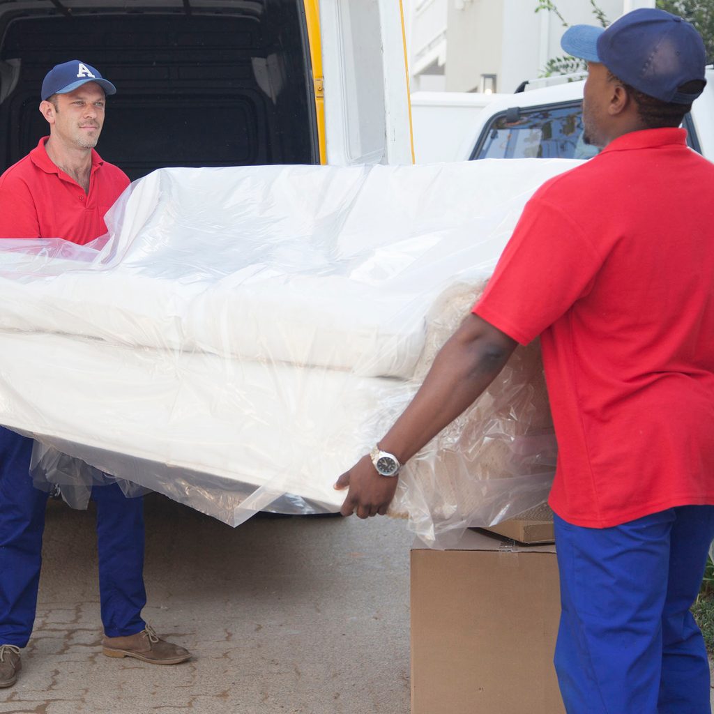 Movers carrying a white couch