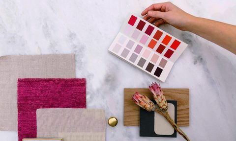 person using color swatches with magenta fabric
