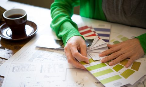 Person looking at paint swatches.