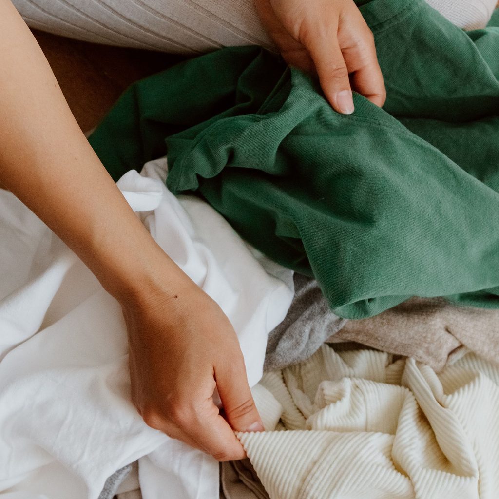 Person sorting through old clothes
