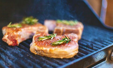 healthy pork chop recipes chops cooking on outdoor patio grill with smoke and flames photo series