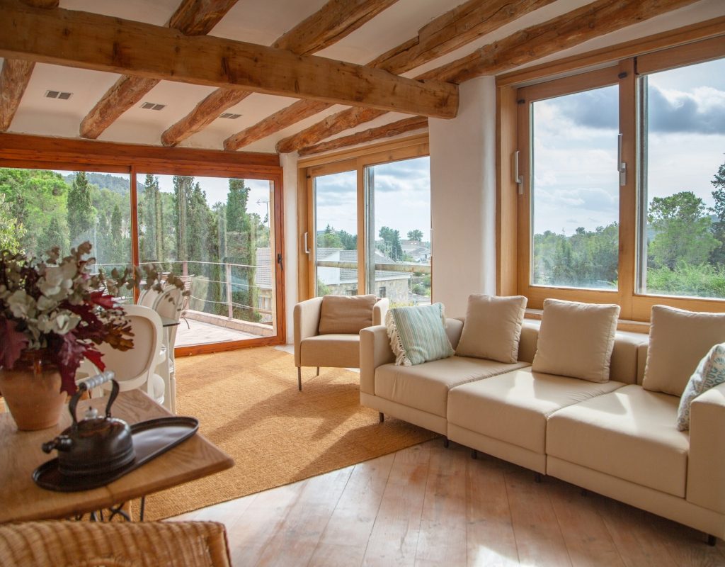 rustic mediterranean living room with neutral colors and exposed wood beams