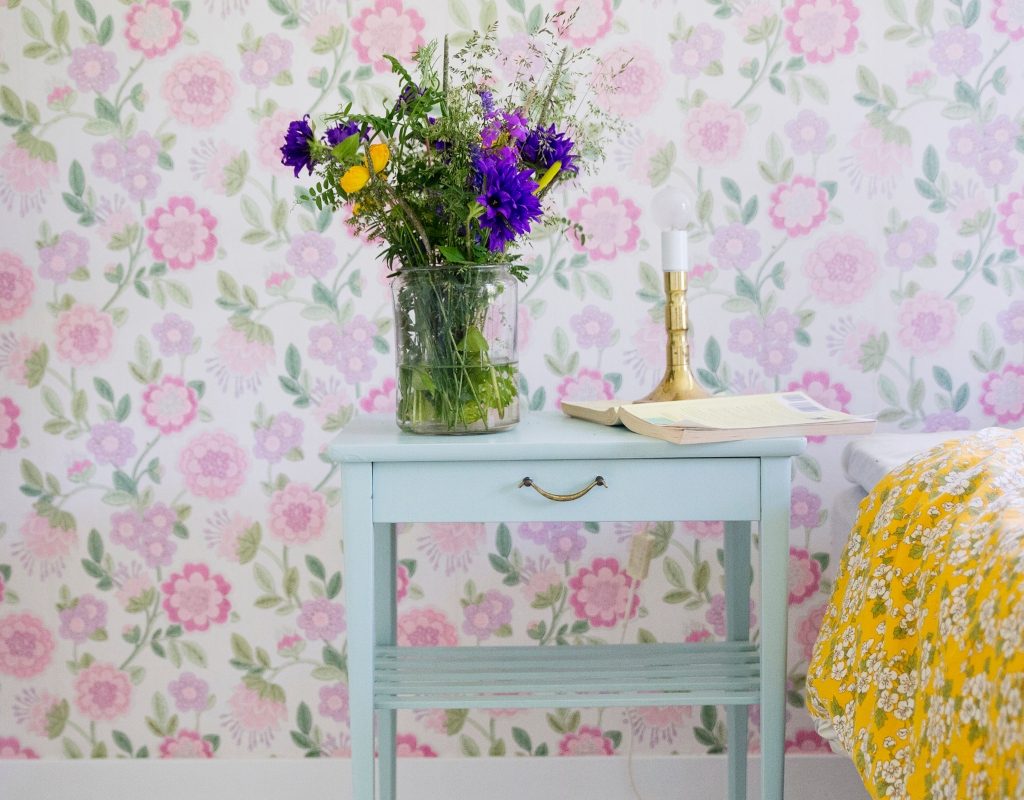 flower patterned wallpaper with flower vase on nightstand