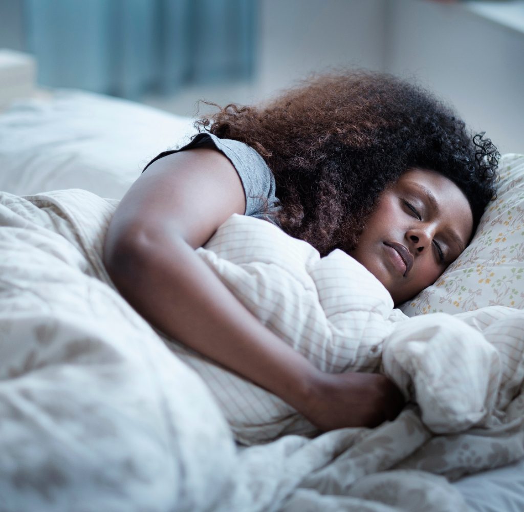 Woman sleeping comfortably in bed.